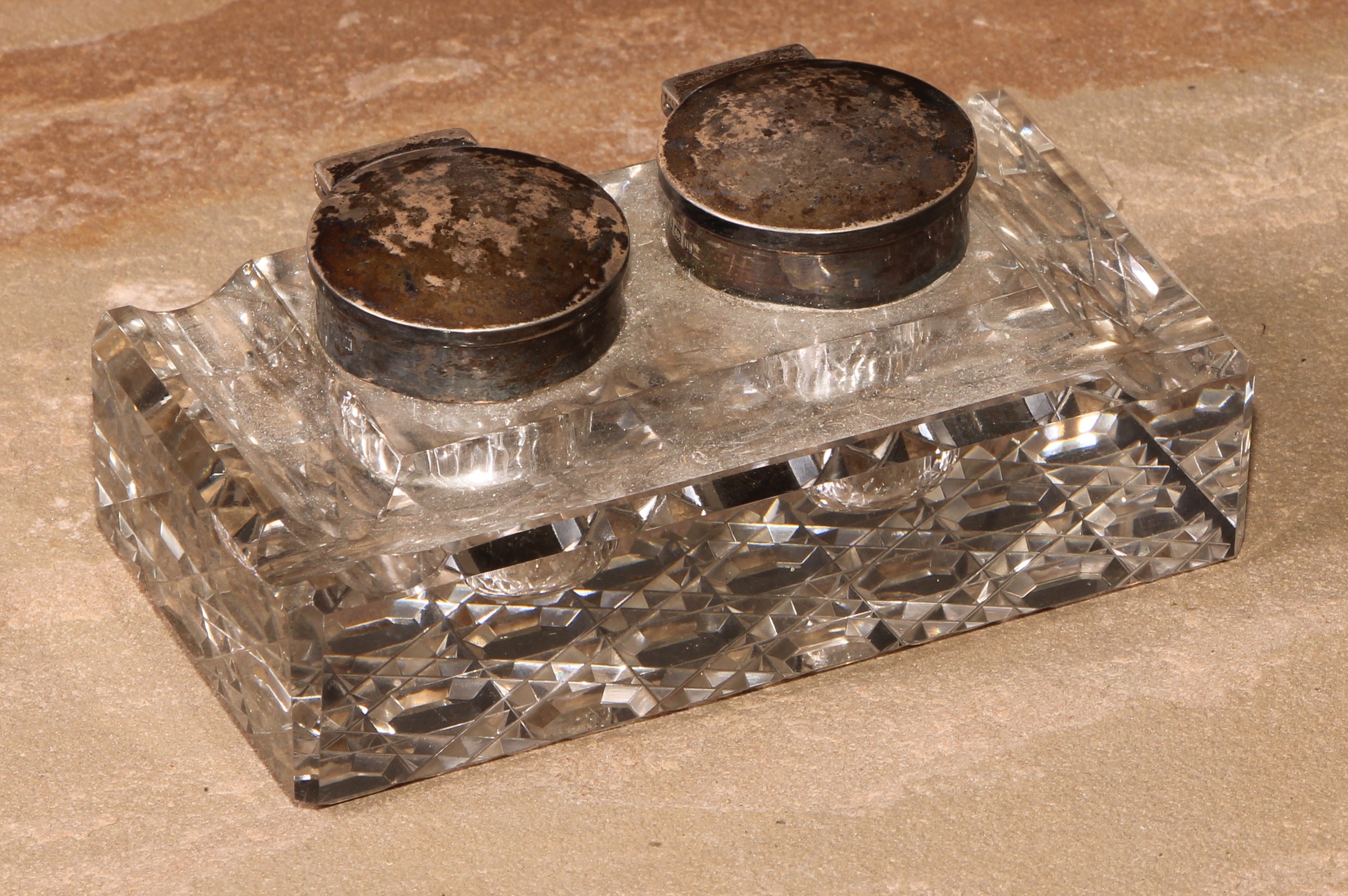 A George V silver mounted twin-section desk inkwell, hinged covers, hobnail-cut base, 11.5cm wide,