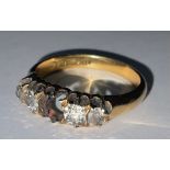 An 18ct gold and diamond five stone ring, set old brilliant cut stones, the central stone missing,