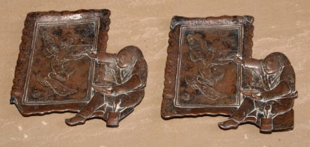 A pair of Japanese antimony card trays, in relief with an artist at work, 14.5cm long