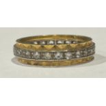 An 18ct white and yellow gold eternity ring, set with diamond chips, size O/P, 4.7g