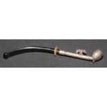 An early 20th century silver coloured metal pipe or cheroot holder, the stem surmounted by a bear,