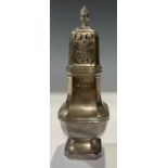 A George V silver sugar caster, pierced domed cover with spire finial, canted square base, 18.5cm, A