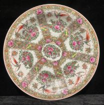 A large Chinese famille rose charger, decorated in polychrome with fanciful birds, butterflies and