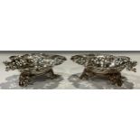 A pair of late Victorian silver heart shaped bon-bon dishes, pierced borders, three scroll feet,