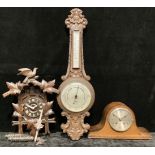 A Black Forest type cuckoo clock; an oak Napoleon hat mantel clock; a carved oak wheel barometer, J.