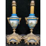 A pair of Louise XV style porcelain and gilt metal, table lamps, painted with stone bridge over