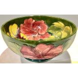 A Moorcroft Hibiscus pattern bowl, tube lined with flowers on a green ground, 20cm diameter, Queen