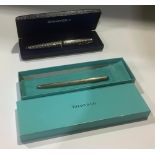 A Tiffany & Co. silver propelling ballpoint pen, marked 925 Sterling, with pouch, boxed; a