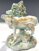 A Derby patchmark model, cow and calf beneath a leafy bough, 12cm, c.1770