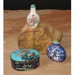 A Chinese porcelain flatenned ovoid snuff bottle, moulkded and decorated in polychrome enamels