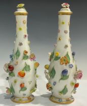 A pair of Meissen elongated ovoid vases and covers, each encrusted with flowers and fruit, flower