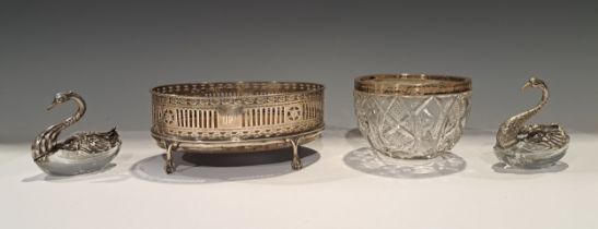 A Georgian silver pierced oval table centre stand, mahogany base, raised on four ball and claw feet,