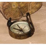 An early 20th century brass compass, silvered dial, 6cm diam