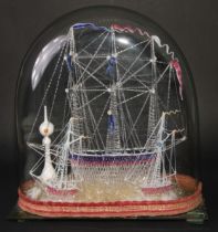 A late 19th century glass model ship diorama, tall ship with sailors climbing the rigging, flanked
