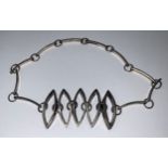 A silver coloured metal modernist choker necklace, the five slender navette shaped panels divided