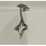 A silver necklace, by Ivan Tarratt, the pendant as a stylised space age star form, Birmingham
