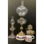 A Victorian oil lamp, clear cut glass font, brass knopped column, ceramic base, cut glass ovoid