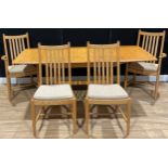 An Ercol extending table, 72.5cm high, 152cm opening to 202.5cm long, 92cm wide; a set of four Ercol