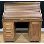 An Art Deco period oak tambour roll top desk, 126cm high, 125cm wide, 76.5cm deep, c.1925