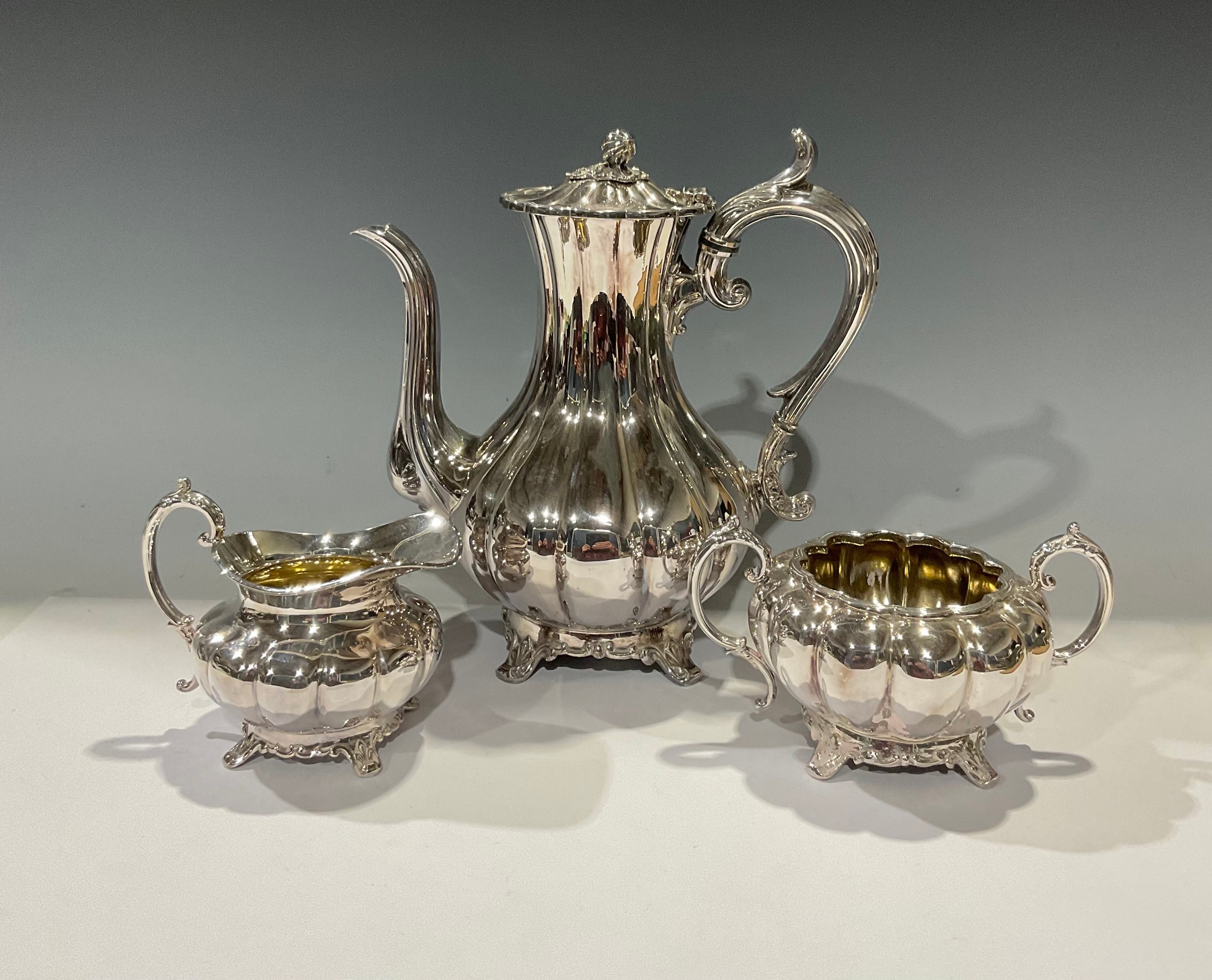 A Victorian EPBM three piece pumpkin shaped coffee service, the coffee pot with bud finial, acanthus