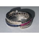 A 9ct white gold eternity ring set with square cut sapphires and rubies, two pivoting arms set