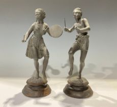 A pair of early 20th century spelter figures, as an African musician and dancer, turned wood