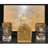 A pair of carved oak bookends, as Bretons, signed E. Morlet (Louis Emile Morlet), 15cm high; another