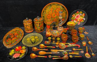 A collection of Russian Khokhloma ware, including a jars, plates, a bowl as a chicken, tray, other