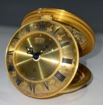 A Jaeger gilt brass circular folding eight day travel alarm clock, pierced foliate openwork case,