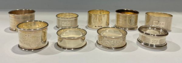 An Elizabeth II silver engine turned napkin ring, monogrammed, Birmingham 1961; eight other silver