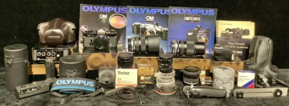 An Olympus OM-2n camera, instructions and original box; an Olympus Zuiko MO Auto-Zoom 35-70mm lens;