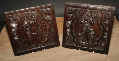 A pair of North European oak panels, carved with figures emblematic of the Autumn and Winter, 19cm x