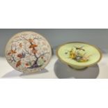 An early 19th century Derby Imari palette dish, printed and painted with a pair of birds perched