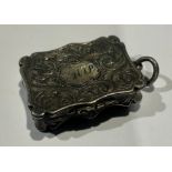 A Victorian silver vinaigrette, engraved with foliate scrolls, pierced hinged grille, suspension