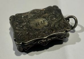 A Victorian silver vinaigrette, engraved with foliate scrolls, pierced hinged grille, suspension