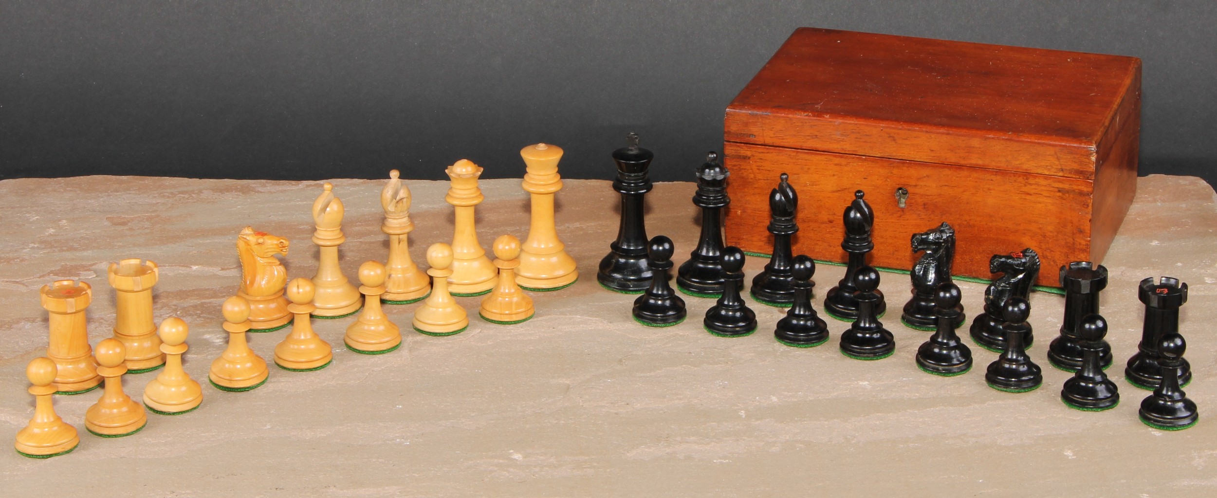 A boxwood and ebonised Staunton chess set, marked for King’s side, the Kings 7cm high, mahogany box