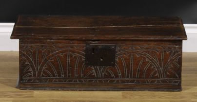 A late 17th century oak boarded table box, hinged top, the front carved with leafy lunettes, 22cm