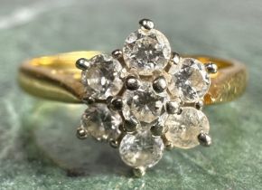 A diamond cluster ring, daisy head set with seven round brilliant cut diamonds, total estimated