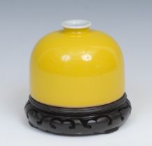 A Chinese monochrome taibai zun, yellow glaze, 11cm diameter, six character mark, hardwood stand