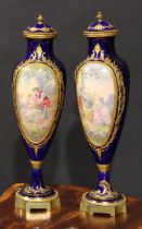 A pair of French gilt metal mounted porcelain slender ovoid vases, painted in the manner of Sèvres