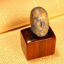 Alfred Lyndhurst Pocock (1882 - 1962), a lapis lazuli pebble carving, Socrates, 4cm long, mounted on