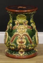 A 19th century majolica garden seat, moulded with masks and scrolls, 46cm high, the top 30cm