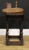A 17th century design oak drop-leaf table, of small proportions, oval top with fall leaves, turned