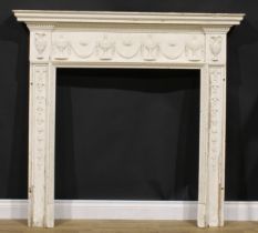 An Adam Revival painted pine fire surround, the apron applied with urns and swags, 132cm high, 141.