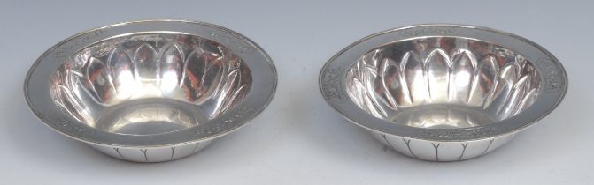 Guild of Handicrafts - a pair of Arts and Crafts silver circular fruit bowls, each chased with