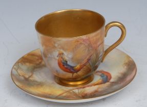 A Royal Worcester cabinet cup and saucer, painted by Walter Sedgley, signed, with golden pheasant,