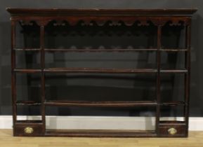 A George III oak Delft rack, outswept cornice above a shaped apron and an arrangement of shelves and