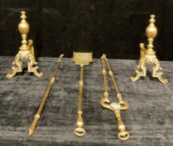 An early 20th century brass hearth suite, comprising three fire irons and a pair of andirons, the