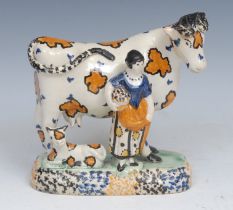 A James Emery Pottery Mexborough cow, calf and milkmaid group, decorated in the typical Pratt ware/