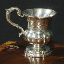 A 19th century Anglo Indian silver fluted campana mug, chased in the Rococo taste with scrolling
